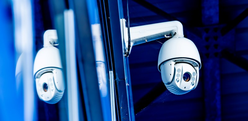 Modern CCTV camera on the wall of an industrial building